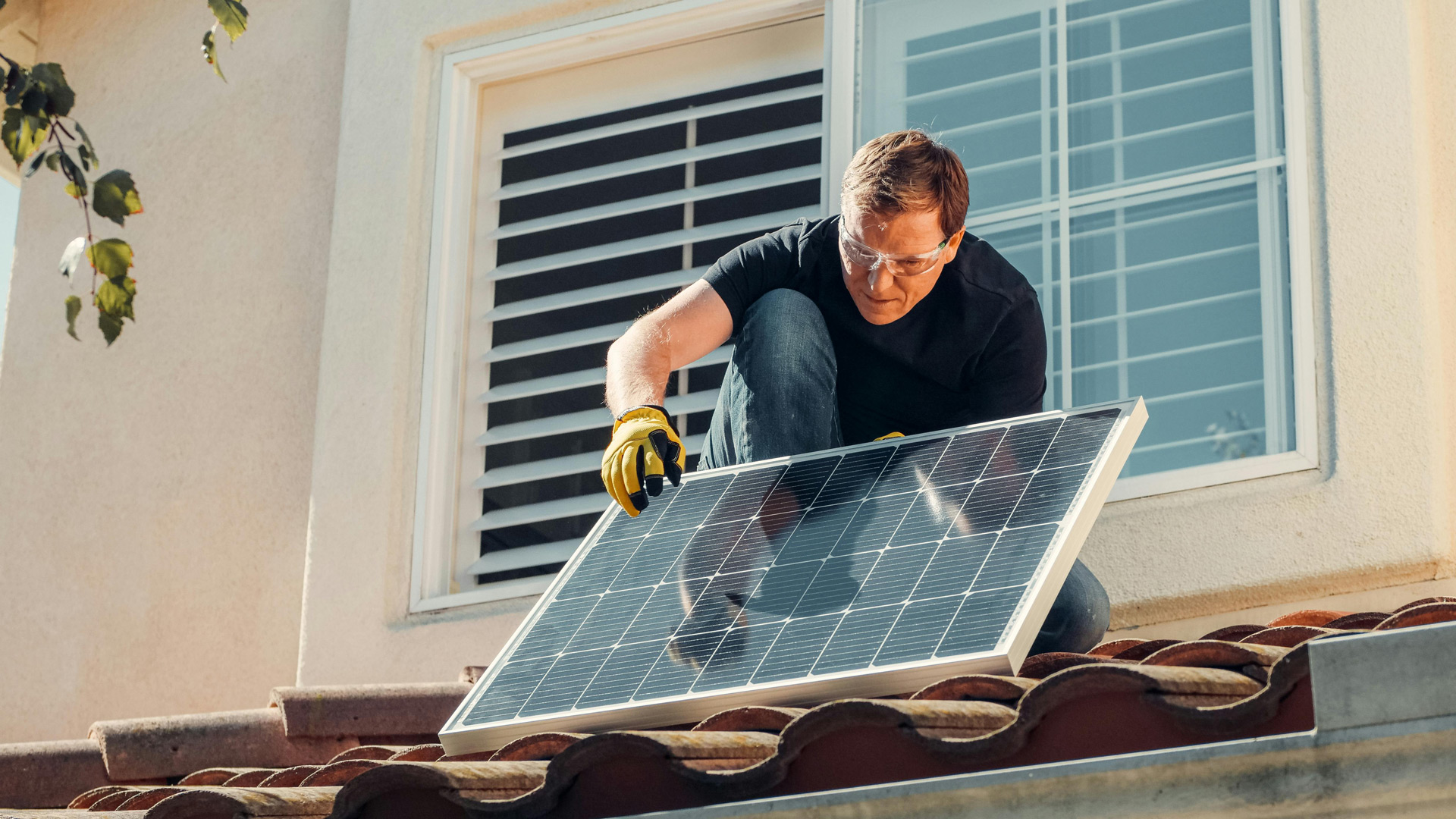 AB-942 Man adjusting his solar panels on the roof